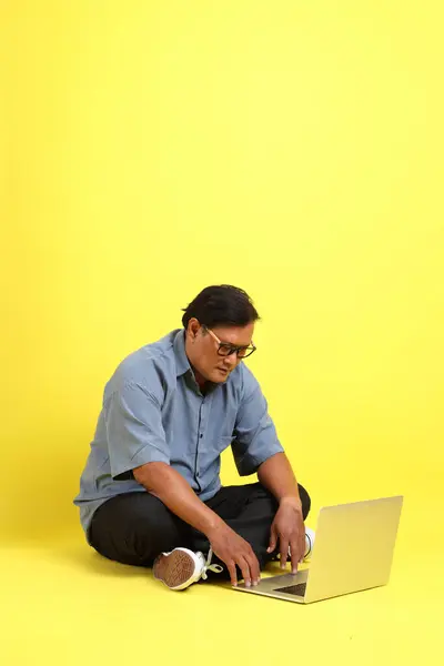 Adult Asian Man Blue Shirt Sitting Yellow Background — 图库照片