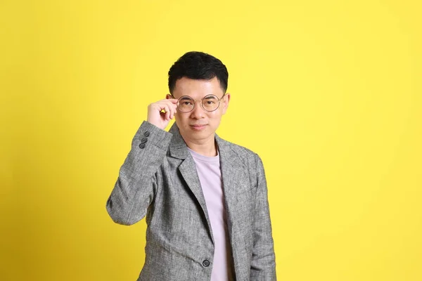 Asian Lgbtq Man Grey Blazer Standing Yellow Background — Zdjęcie stockowe