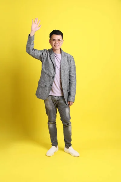 Asian Lgbtq Man Grey Blazer Standing Yellow Background — Zdjęcie stockowe