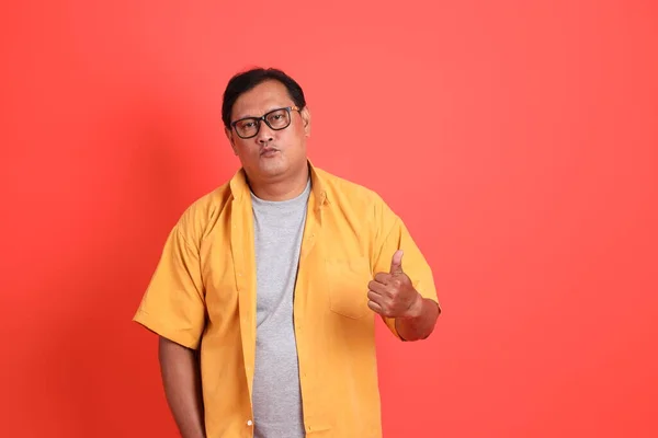 Adult Asian Man Yellow Shirt Standing Orange Background — Stockfoto