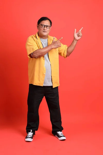 Adult Asian Man Yellow Shirt Standing Orange Background — Fotografia de Stock