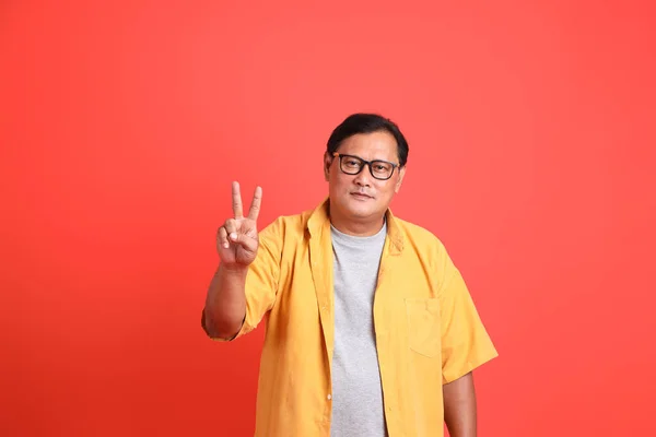 Adult Asian Man Yellow Shirt Standing Orange Background — Stok fotoğraf