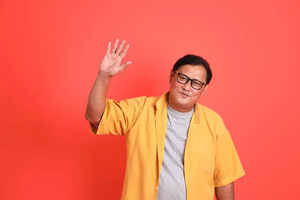 Adult Asian Man Yellow Shirt Standing Orange Background — Stockfoto