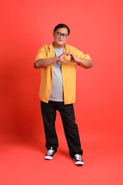 Adult Asian Man Yellow Shirt Standing Orange Background — Stock Photo, Image