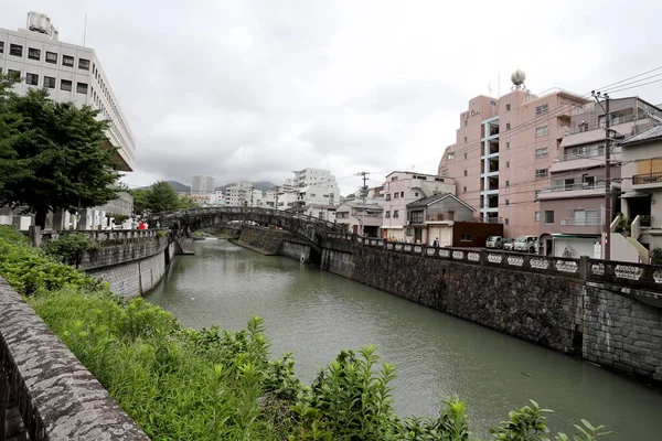 Nagasaki, Japan - July 21, 2022: The Meganebashi Bridge is the ston arch bridge located at Nakashima river in Japan.