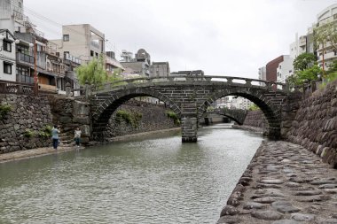 Nagasaki, Japan - July 21, 2022: The Meganebashi Bridge is the ston arch bridge located at Nakashima river in Japan.
