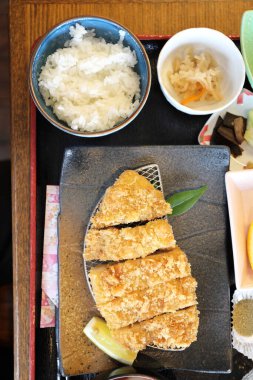 The crispy deep fried pork named donkatsu served with Japanese rice and Miso soup.