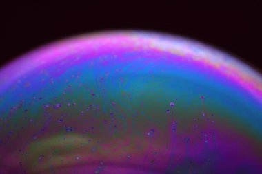 The abstact element on the soap bubble with the dark background.