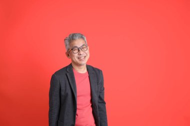 Asyalı kıdemli iş adamı orgazm arka planında duruyor..