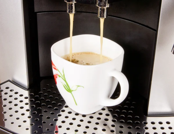 A cup of coffe in a coffee machine — Stock Photo, Image