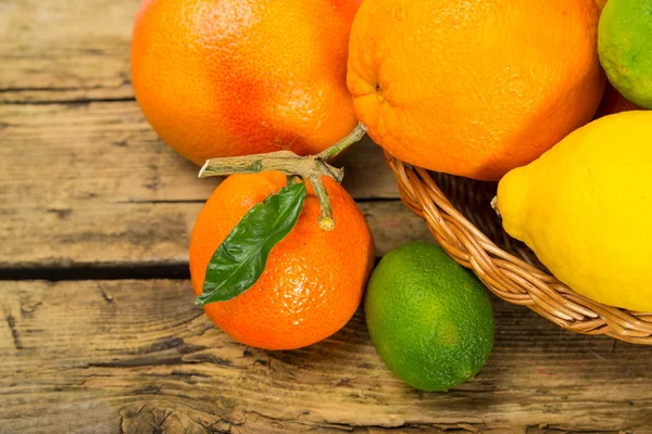 Citrus fruits on wooden background — Stock Photo, Image