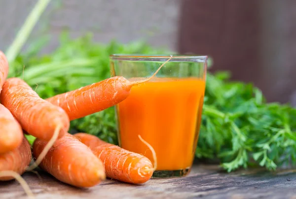 Carrot juice on wooden background — Stock Photo, Image