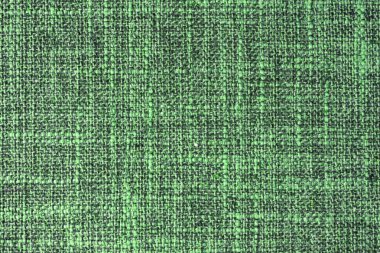 Doğal yeşil kabuklu kumaş ya da kumaşın yakın çekim dokusu. Doğal pamuk veya keten kumaş dokusu. Mavi tuval arka plan. Döşeme, mobilya ve duvarlar için dekoratif kumaş