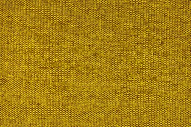 Doğal sarı kabarık kumaş ya da kumaşın yakın çekim dokusu. Doğal pamuk veya keten kumaş dokusu. Mavi tuval arka plan. Döşeme, mobilya ve duvarlar için dekoratif kumaş