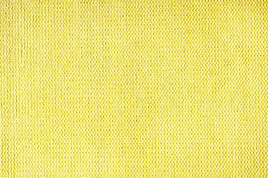 Doğal sarı kabarık kumaş ya da kumaşın yakın çekim dokusu. Doğal pamuk veya keten kumaş dokusu. Mavi tuval arka plan. Döşeme, mobilya ve duvarlar için dekoratif kumaş