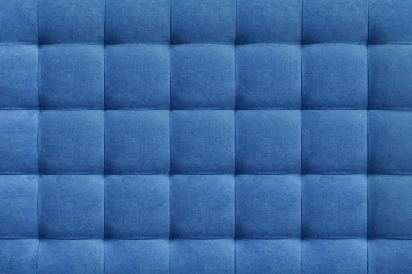 Blue suede leather background for the wall in the room. Interior design, headboards made of furniture fabric, furniture upholstery. Classic checkered pattern for furniture, wall, headboard