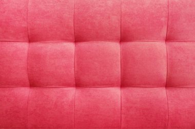 Pink suede leather background for the wall in the room. Interior design, headboards made of furniture fabric, furniture upholstery. Classic checkered pattern for furniture, wall, headboard