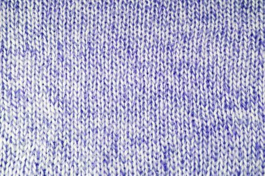 Close up background of knitted wool fabric with dots pattern. Bright blue color wool knitwear texture. Openwork abstract knitted jersey. Fabric abstract backdrop