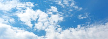 Blue sky with white clouds in sunny day. Beauty clear cloudy sky in sunshine calm air bacground. Natural background texture, backdrop, wallpaper, element for design, long banner