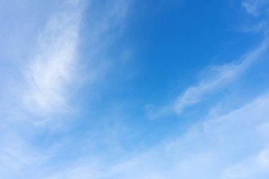 Blue sky with white clouds in sunny day. Beauty clear cloudy sky in sunshine calm air bacground. Natural background texture, backdrop, wallpaper, element for design