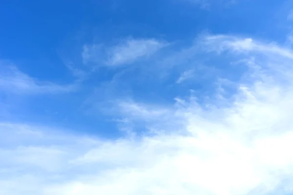 Blue sky with white clouds in sunny day. Beauty clear cloudy sky in sunshine calm air bacground. Natural background texture, backdrop, wallpaper, element for design