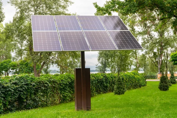 Solar panels in public park backgound. Photovoltaic modules for renewable energy, system of electric generators from the sun. Clean technologies, green and renewable energy, eco friendly electricity