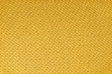 Texture of natural yellow fabric or cloth. Fabric texture diagonal weave of natural cotton or linen textile material. Blue canvas background. Decorative fabric for curtain, furniture, walls, clothes