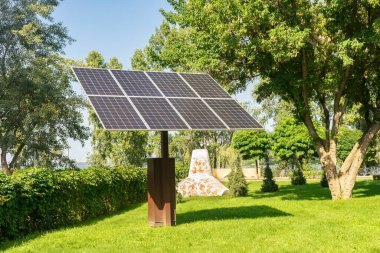 Solar panels in public park backgound. Photovoltaic modules for renewable energy, system of electric generators from the sun. Clean technologies, green and renewable energy, eco friendly electricity