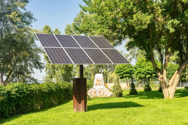 Solar panels in public park backgound. Photovoltaic modules for renewable energy, system of electric generators from the sun. Clean technologies, green and renewable energy, eco friendly electricity