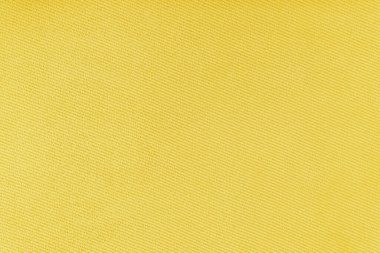 Texture of natural fabric or cloth. Fabric texture diagonal weave of natural cotton or linen textile material. Yellow canvas background. Decorative fabric for curtain, furniture, walls, clothes