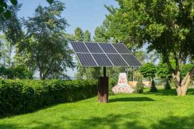 Solar panels in public park backgound. Photovoltaic modules for renewable energy, system of electric generators from the sun. Clean technologies, green and renewable energy, eco friendly electricity