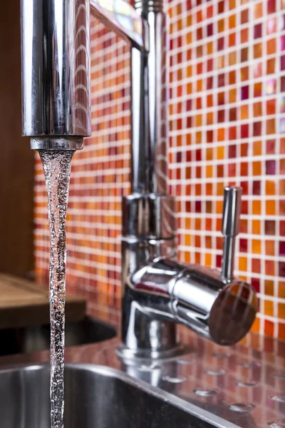 Kitchen faucet flowing — Stock Photo, Image