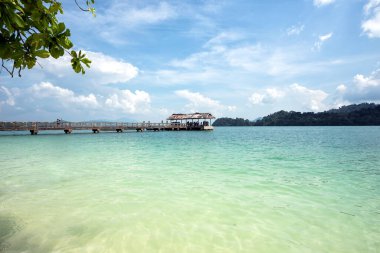 Jetty at Pulau Beras Basah, Langkawi, Malaysia. - The beautiful scenery of long Jetty with clear blue sky and water, Pulau Beras Basah Island, Langkawi, Malaysia. clipart
