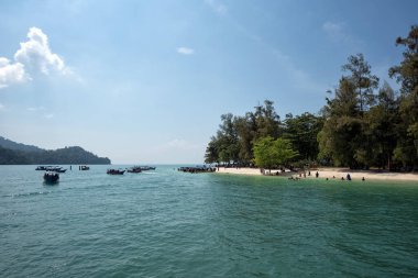 Tekneler turistleri güneşli bir günde Pulau Beras Basah, Langkawi, Malezya 'daki güzel plaja götürüyor..