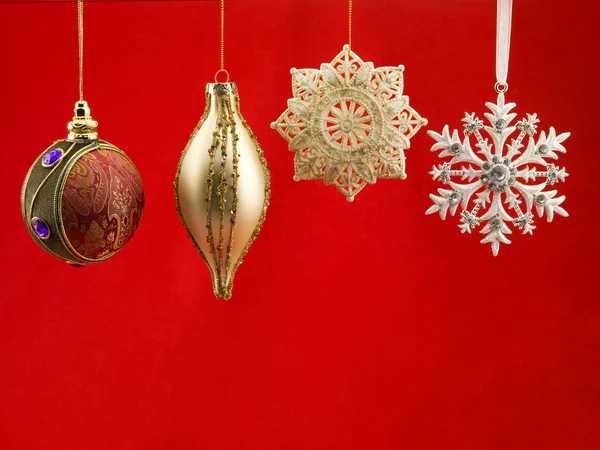 Christmas bauble against red background — Stock Photo, Image