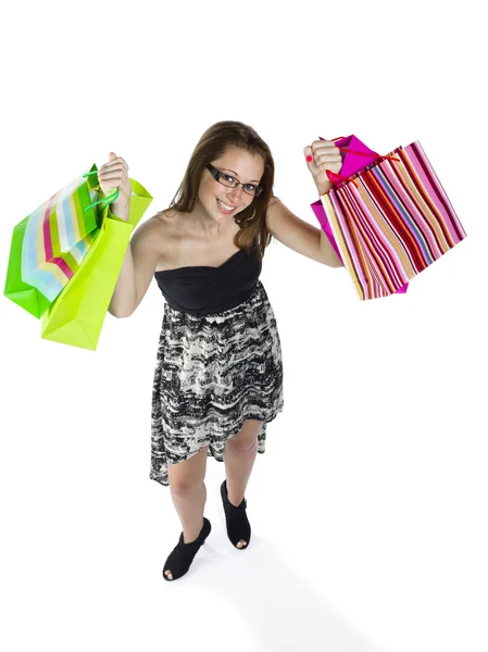 High angle view of a teenage girl holding up shopping bags — Stock Photo, Image