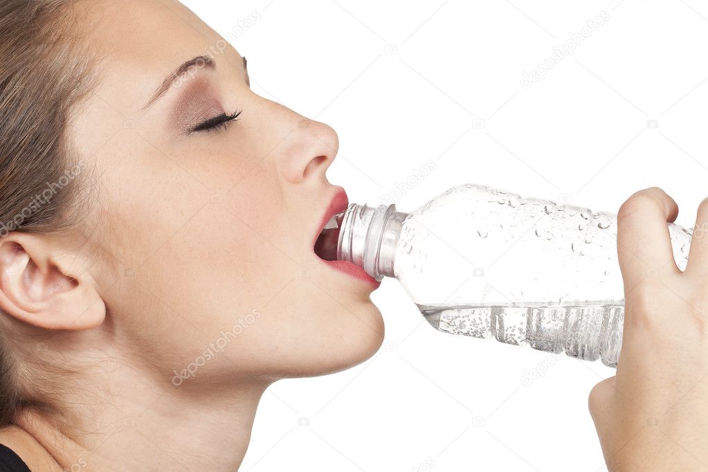 Teen model closup of drinking water out of clear water bottle