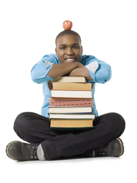 Ragazzo adolescente con pila di libri e mela — Foto Stock