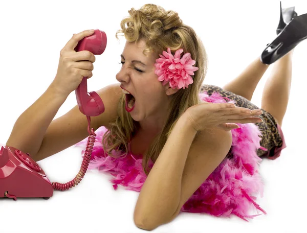 Furious blonde woman screaming while talking on landline phone — Stock Photo, Image