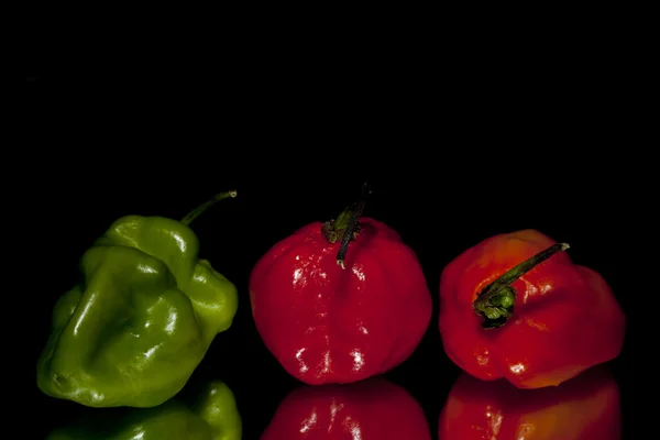 Green red and orange habanero peppers — Stock Photo, Image