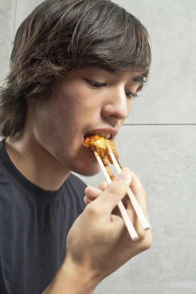 Τύπος τρώει χρησιμοποιώντας chopstick — Φωτογραφία Αρχείου