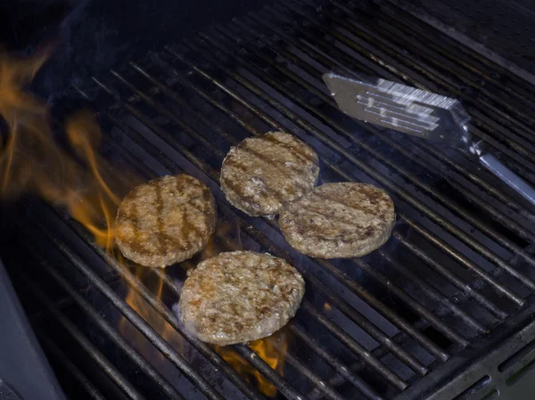 Hamburger patties on a grill — Stock Photo, Image