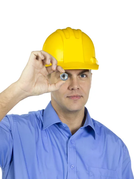 Handsome architect looking through a nut — Stock Photo, Image