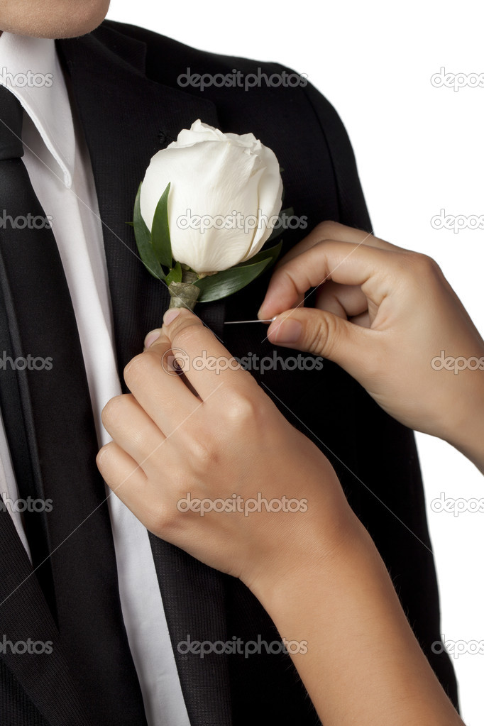 Hand putting a flower in collar