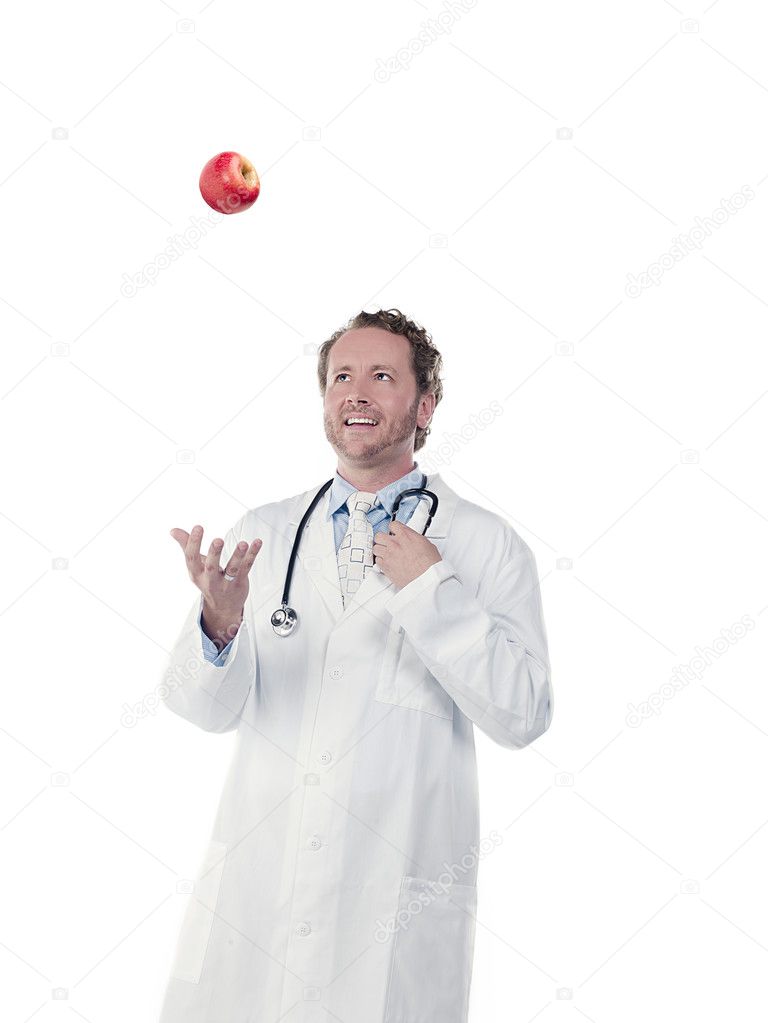 happy doctor tossing apple in air