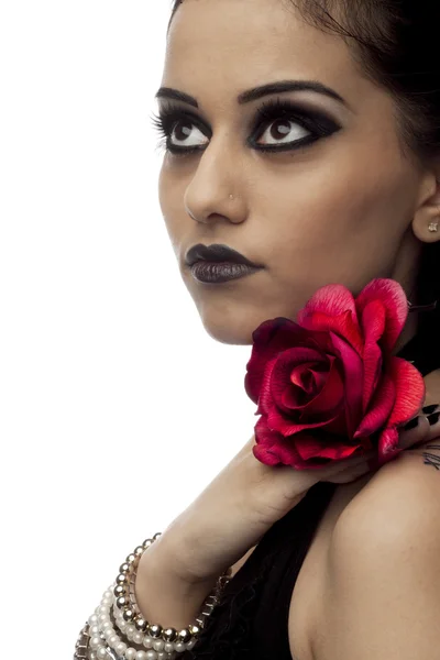 Beautiful young indian woman with a rose looking away — Stock Photo, Image