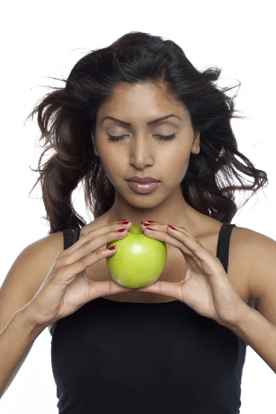 Beautiful young woman holding a green apple — Stock Photo, Image