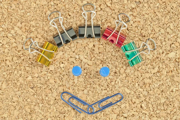 Happy face made of colorful clips — Stock Photo, Image