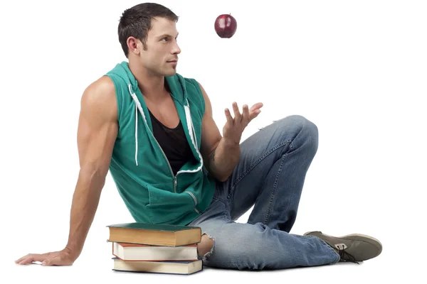 Man throwing the apple while sitting — Stock Photo, Image