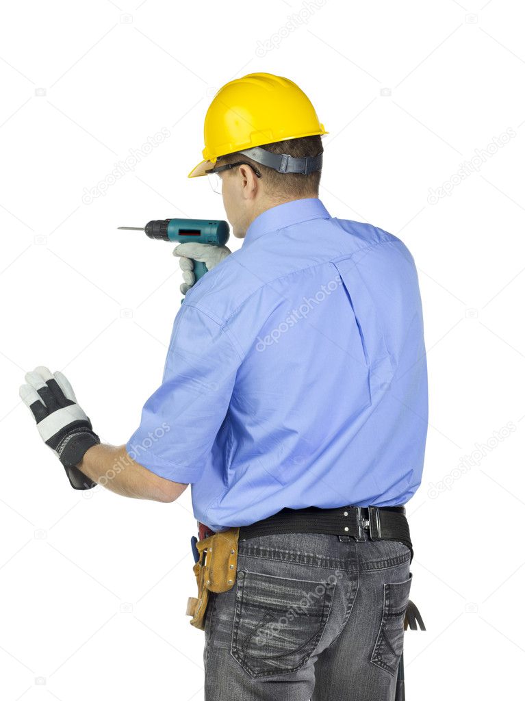 Man in safety gears holding electric drill machine